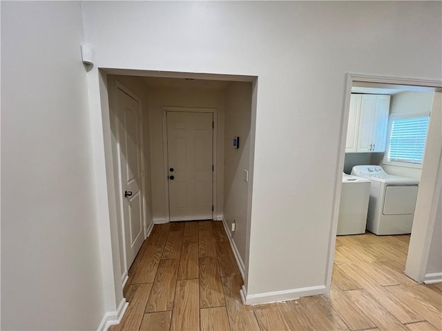 701 Cameron M Alexander Blvd NW, Atlanta, GA 30318 - hall with light wood-type flooring, washing machine and clothes dryer, and baseboards