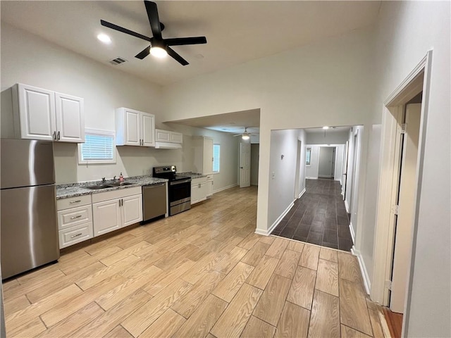 701 Cameron M Alexander Blvd NW, Atlanta, GA 30318 - kitchen featuring stainless steel appliances, a ceiling fan, a sink, and light wood-style flooring
