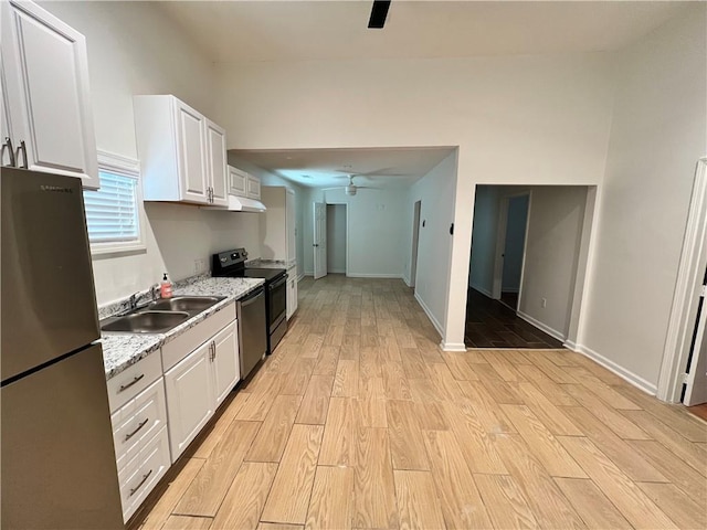 701 Cameron M Alexander Blvd NW, Atlanta, GA 30318 - kitchen featuring appliances with stainless steel finishes, a ceiling fan, under cabinet range hood, light wood-style flooring, and white cabinetry