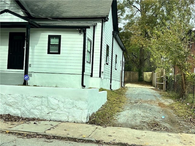 701 Cameron M Alexander Blvd NW, Atlanta, GA 30318 - view of home's exterior featuring dirt driveway and a shingled roof
