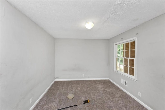 5267 Sheppard Ln, Stone Mountain, GA 30083 - carpeted empty room featuring baseboards and a textured ceiling