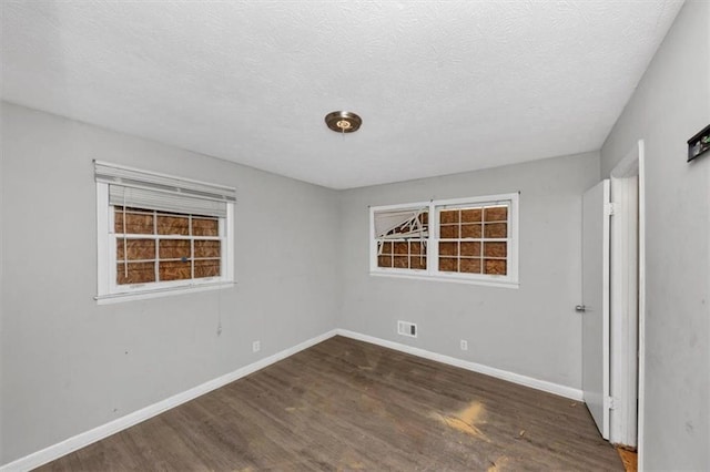 5267 Sheppard Ln, Stone Mountain, GA 30083 - unfurnished bedroom featuring wood finished floors and a textured ceiling