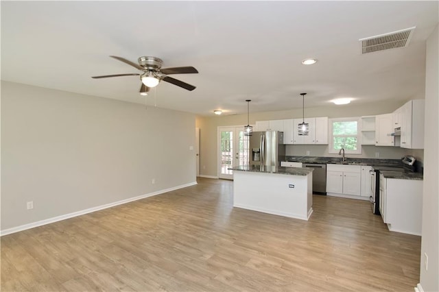 537 Eastside Dr, Dacula, GA 30019 - kitchen with appliances with stainless steel finishes, a center island, a sink, healthy amount of natural light, and recessed lighting