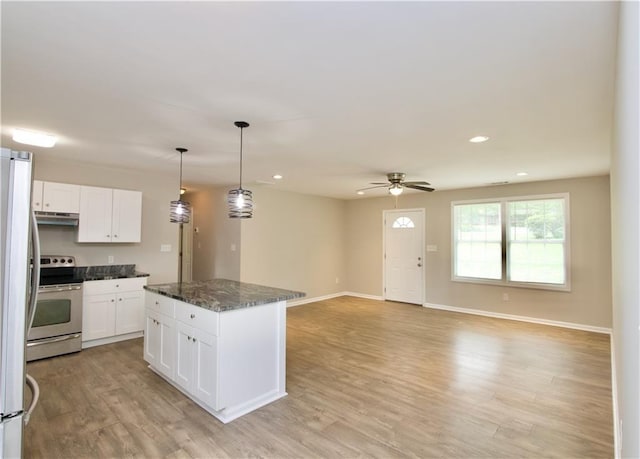 537 Eastside Dr, Dacula, GA 30019 - kitchen with electric stove, white cabinets, light wood-style flooring, ceiling fan, and a center island