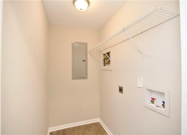 537 Eastside Dr, Dacula, GA 30019 - washroom featuring electric panel, electric dryer hookup, washer hookup, baseboards, and wood finished floors