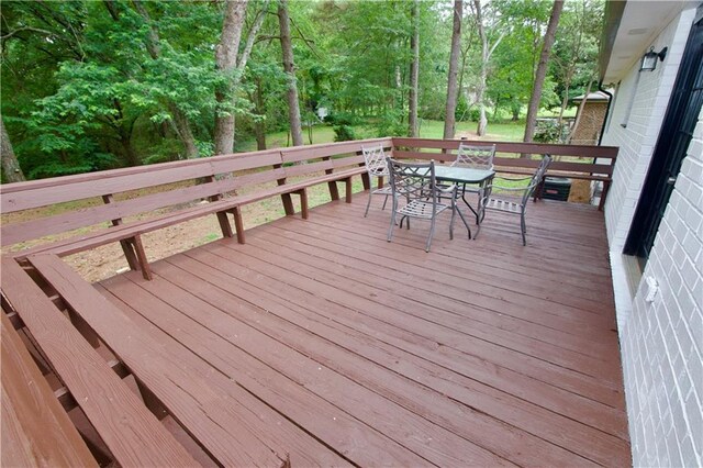 537 Eastside Dr, Dacula, GA 30019 - wooden terrace featuring outdoor dining space and view of scattered trees