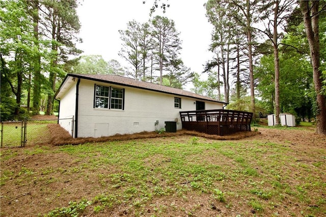537 Eastside Dr, Dacula, GA 30019 - rear view of house with a wooden deck, crawl space, brick siding, and a gate