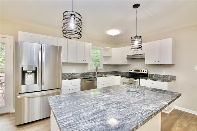 537 Eastside Dr, Dacula, GA 30019 - kitchen featuring stainless steel appliances, under cabinet range hood, white cabinets, light wood finished floors, and a sink