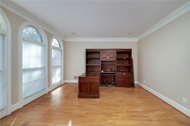 unfurnished office with baseboards, ornamental molding, light wood-style floors, and visible vents