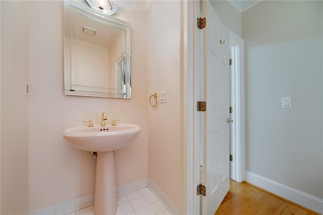 bathroom with baseboards and crown molding