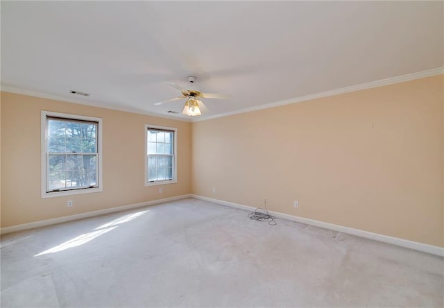 empty room featuring visible vents, baseboards, and ornamental molding