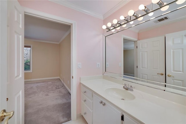 bathroom featuring baseboards, ornamental molding, vanity, and visible vents