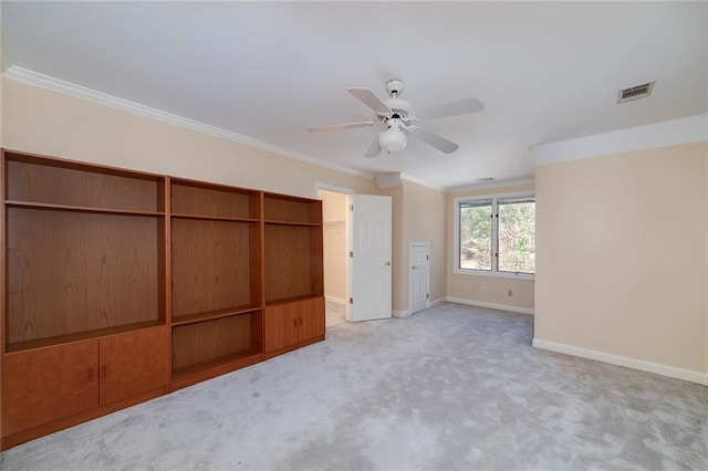 unfurnished bedroom with visible vents, ornamental molding, a closet, baseboards, and carpet flooring