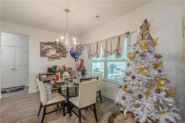 446 Vandenburg Dr, Villa Rica, GA 30180 - dining space featuring a chandelier, baseboards, and wood finished floors
