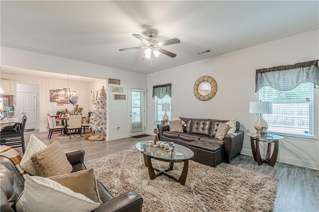 446 Vandenburg Dr, Villa Rica, GA 30180 - living area featuring a chandelier, plenty of natural light, ceiling fan, and light wood-type flooring