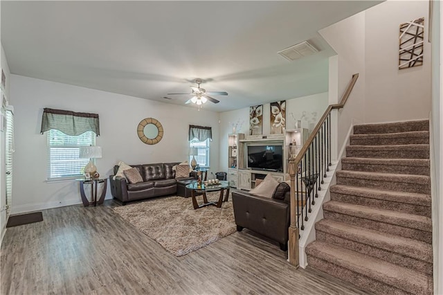 446 Vandenburg Dr, Villa Rica, GA 30180 - living area with wood finished floors, stairway, ceiling fan, and baseboards