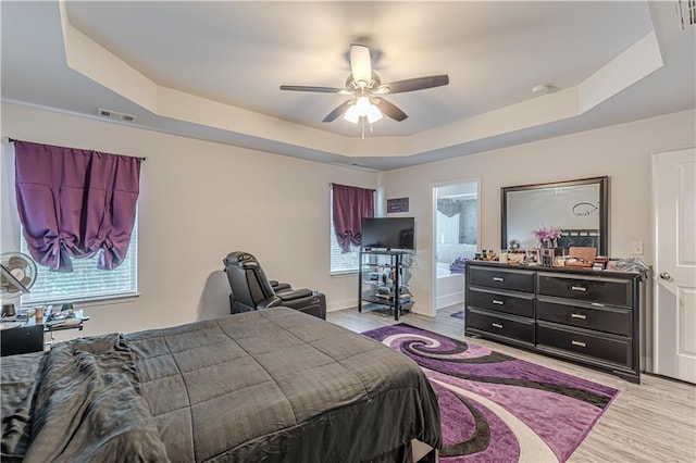 446 Vandenburg Dr, Villa Rica, GA 30180 - bedroom featuring a tray ceiling, light wood-style floors, and ceiling fan