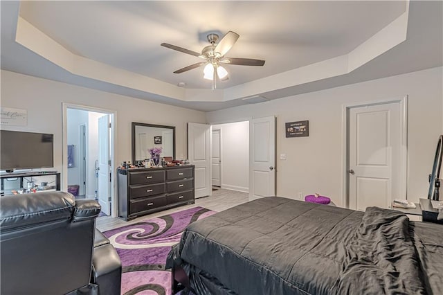 446 Vandenburg Dr, Villa Rica, GA 30180 - bedroom featuring a raised ceiling, light wood-style floors, ceiling fan, and connected bathroom