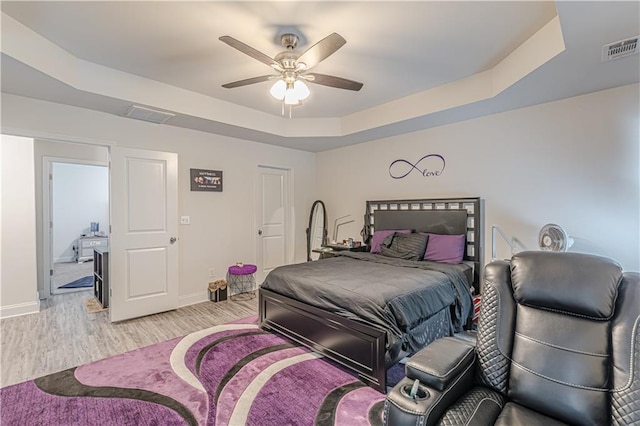 446 Vandenburg Dr, Villa Rica, GA 30180 - bedroom with a tray ceiling, light wood-style floors, baseboards, and ceiling fan