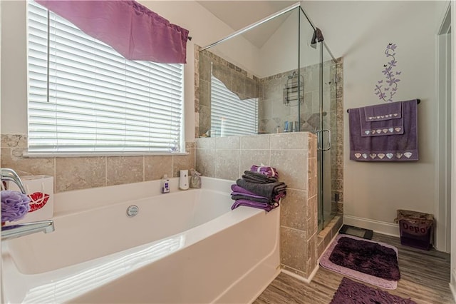 446 Vandenburg Dr, Villa Rica, GA 30180 - bathroom with a bath, a stall shower, wood finished floors, and healthy amount of natural light