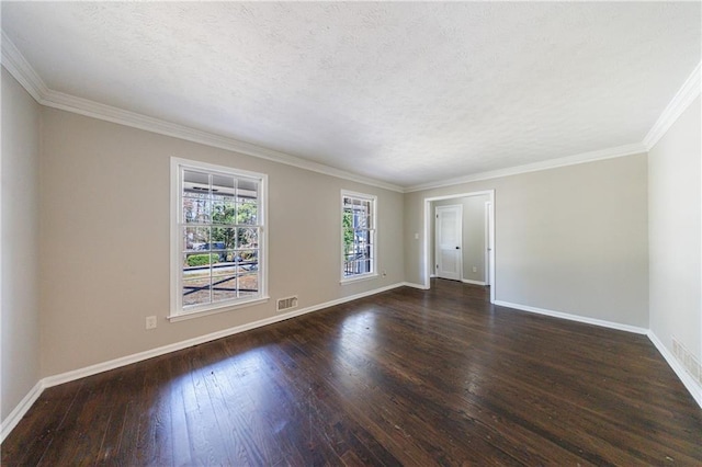 spare room featuring visible vents, a textured ceiling, hardwood / wood-style floors, crown molding, and baseboards