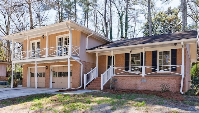 split level home featuring a garage, brick siding, a porch, and driveway