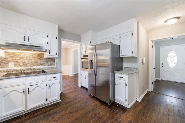 kitchen with under cabinet range hood, stainless steel appliances, dark wood-type flooring, and white cabinetry