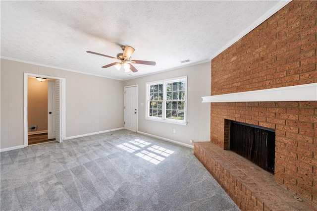 unfurnished living room with a fireplace, a textured ceiling, and ornamental molding