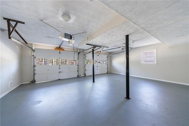 garage featuring a garage door opener and baseboards