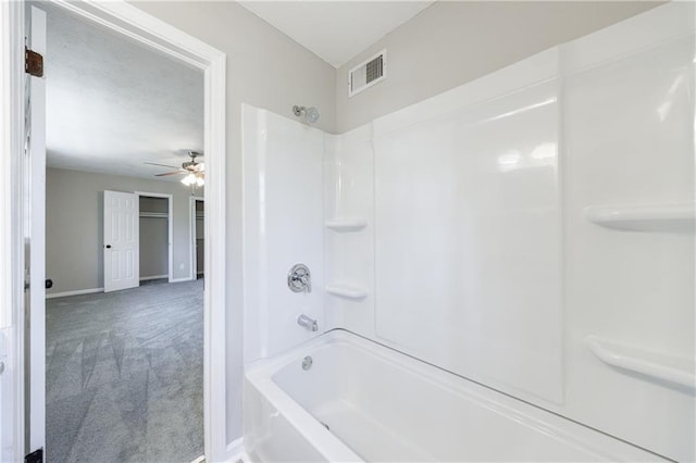 bathroom with shower / washtub combination, baseboards, visible vents, and ceiling fan