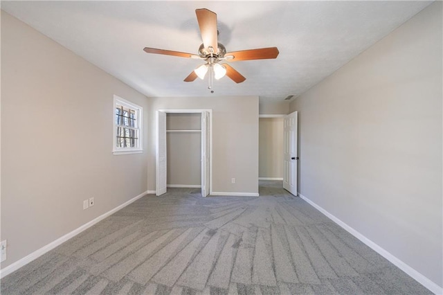 unfurnished bedroom featuring a closet, ceiling fan, carpet, and baseboards