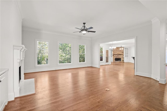 unfurnished living room featuring a stone fireplace, crown molding, and wood-type flooring