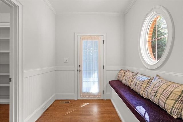 doorway to outside with crown molding and wood-type flooring