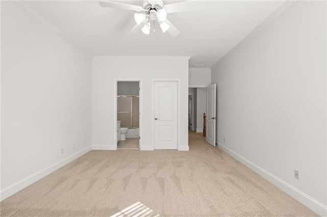 unfurnished bedroom featuring ensuite bath, crown molding, light colored carpet, and ceiling fan