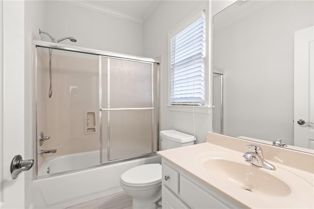 full bathroom with vanity, toilet, ornamental molding, and shower / bath combination with glass door