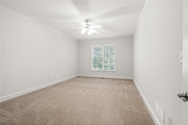 carpeted empty room with crown molding and ceiling fan