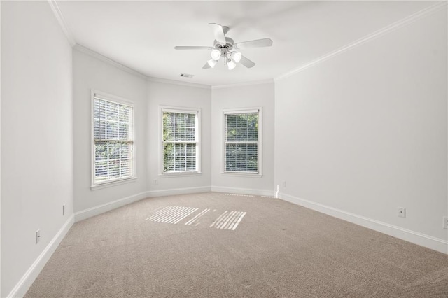 empty room featuring ceiling fan, ornamental molding, and light colored carpet