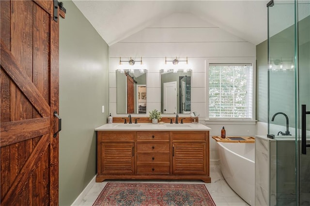 full bathroom featuring vaulted ceiling, marble finish floor, a sink, and a washtub