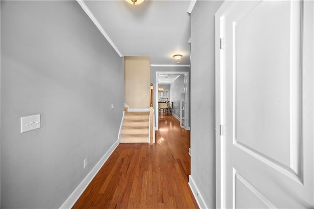 hall with baseboards, stairway, crown molding, and wood finished floors