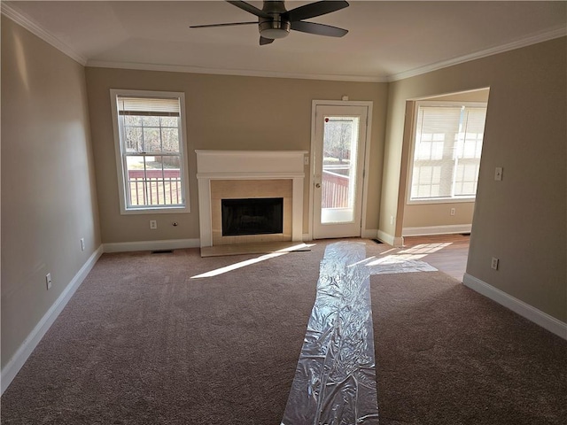 unfurnished living room featuring ornamental molding, carpet flooring, and ceiling fan