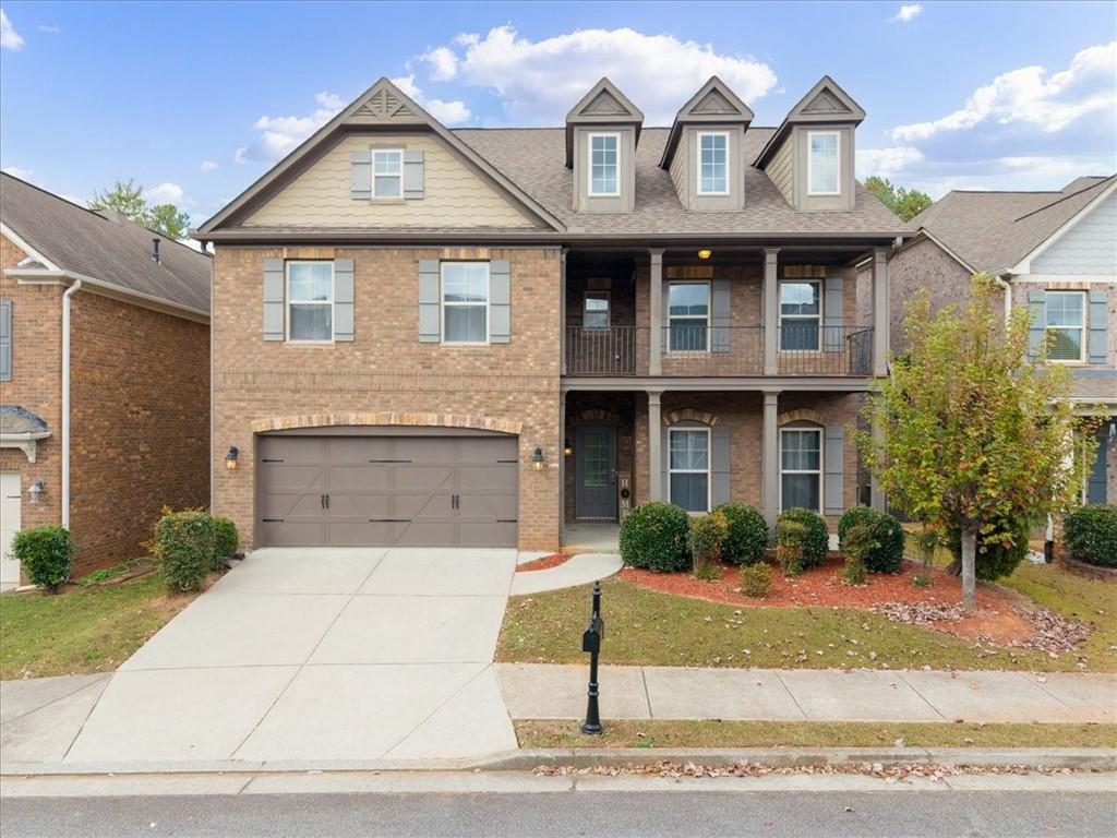 view of front of house featuring a balcony and a garage