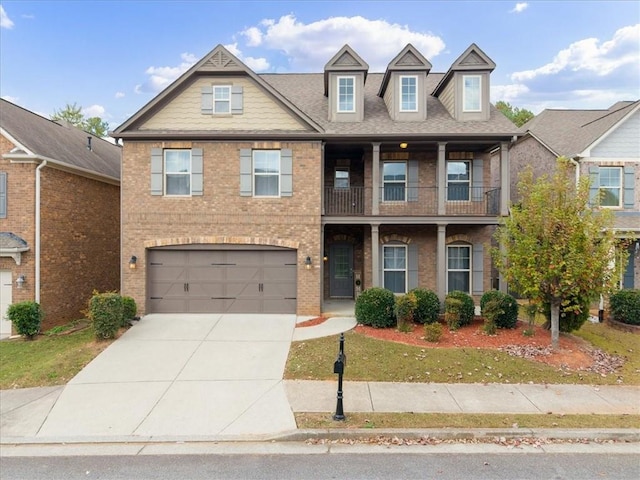 view of front of house featuring a balcony and a garage