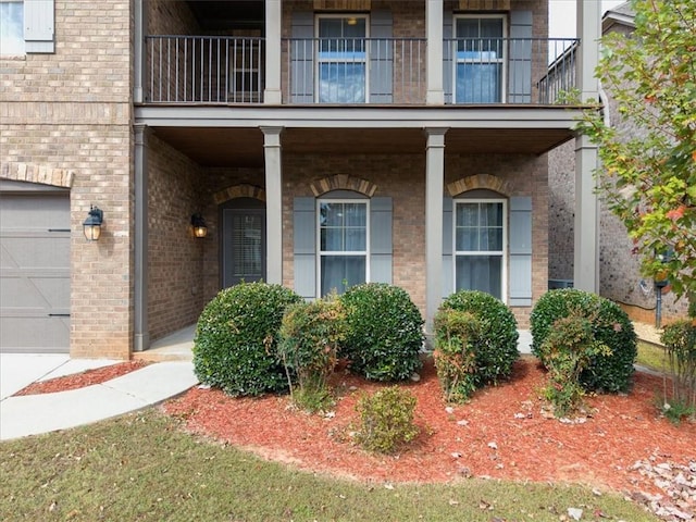 doorway to property with a balcony and a garage