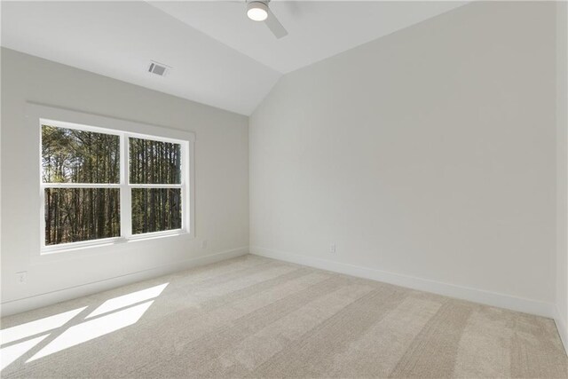 carpeted spare room with ceiling fan