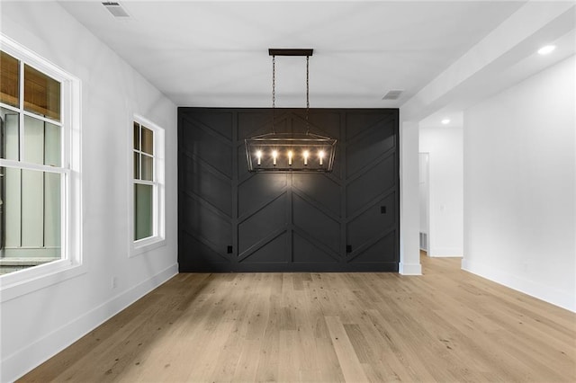 unfurnished dining area with light wood-type flooring