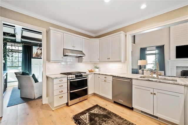 kitchen featuring plenty of natural light, under cabinet range hood, visible vents, and appliances with stainless steel finishes