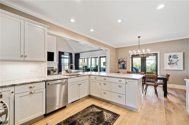 kitchen featuring light wood-type flooring, a wealth of natural light, a sink, and stainless steel dishwasher