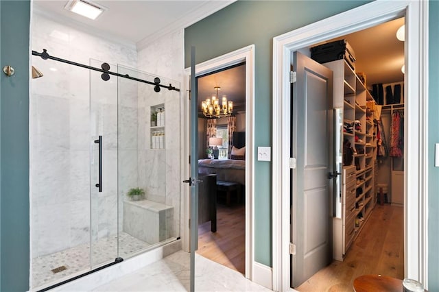 ensuite bathroom with ornamental molding, ensuite bath, a shower stall, and a walk in closet