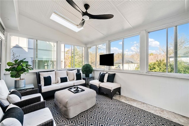 sunroom / solarium with ceiling fan and lofted ceiling with skylight