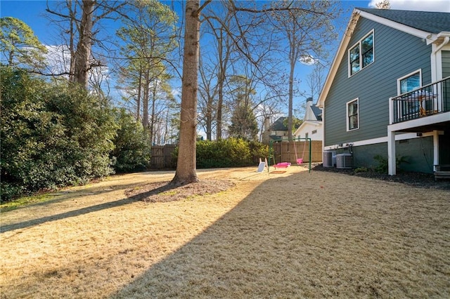 view of yard with fence and cooling unit